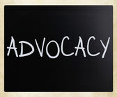The word Advocacy handwritten with white chalk on a blackboard