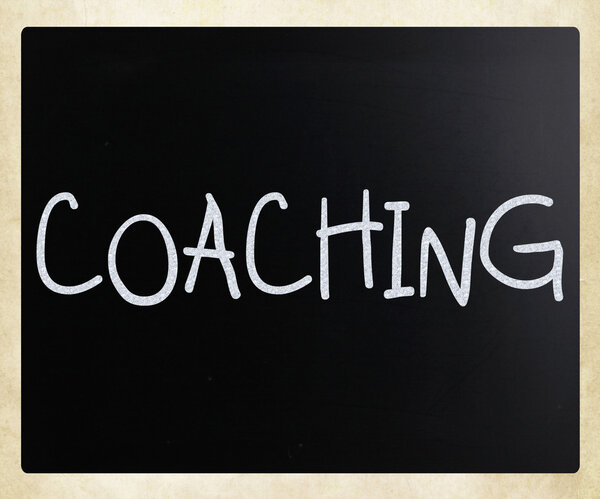 "Coaching "handwritten with white chalk on a blackboard
