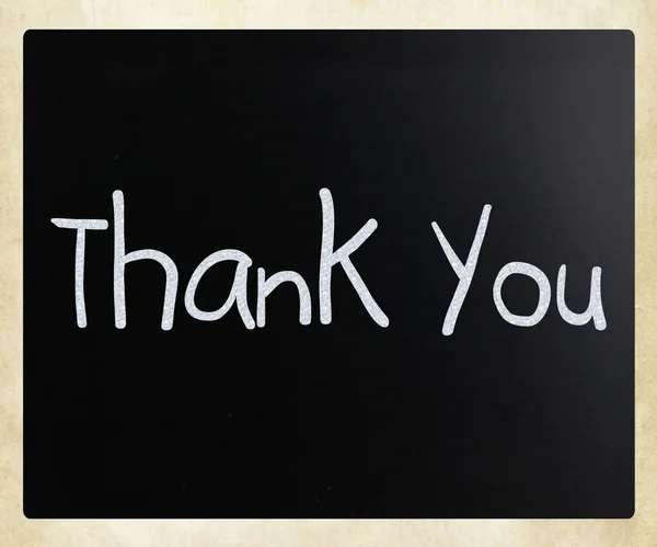 "Thank you "handwritten with white chalk on a blackboard — стоковое фото
