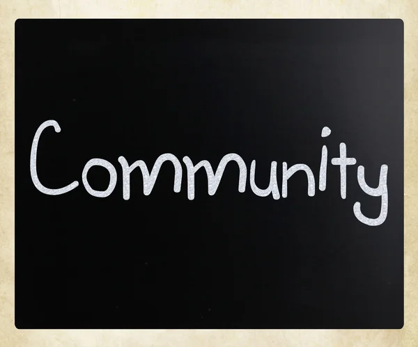 "Community" handwritten with white chalk on a blackboard — Stock Photo, Image
