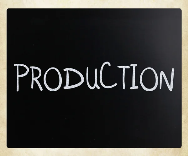 "Production" handwritten with white chalk on a blackboard — Stock Photo, Image