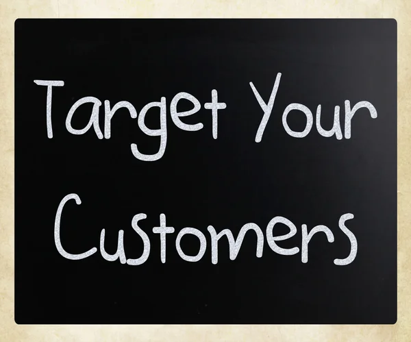"Target your customers" handwritten with white chalk on a blackb — 스톡 사진