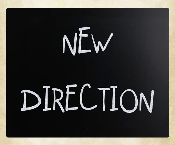 "New direction" handwritten with white chalk on a blackboard — Stock Photo, Image