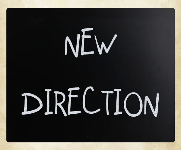 "New direction "handwritten with white chalk on a blackboard — стоковое фото