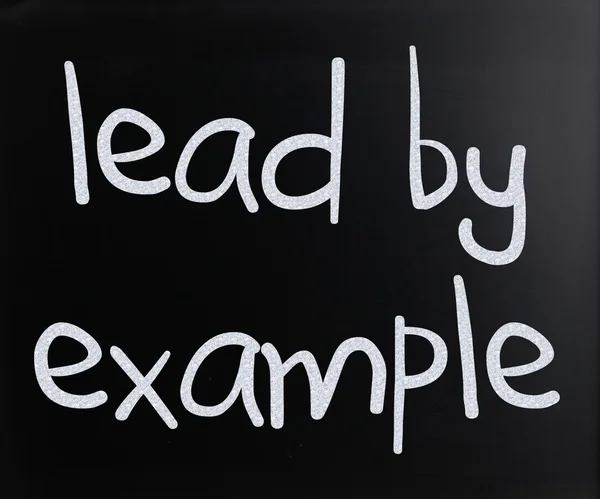 "Lead by example" handwritten with white chalk on a blackboard — Stok fotoğraf