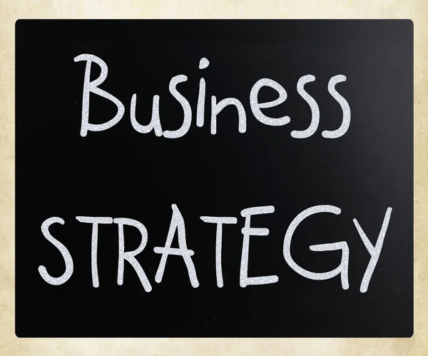 "Business strategy" handwritten with white chalk on a blackboard — Stock Photo, Image