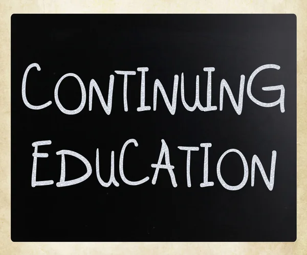 "Continuing Education" handwritten with white chalk on a blackbo — Stock Photo, Image