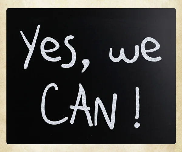 "Yes, we can!" handwritten with white chalk on a blackboard — Stock Photo, Image
