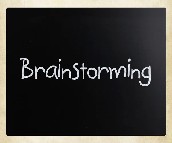 "Brainstorming" handwritten with white chalk on a blackboard — Stock Photo, Image