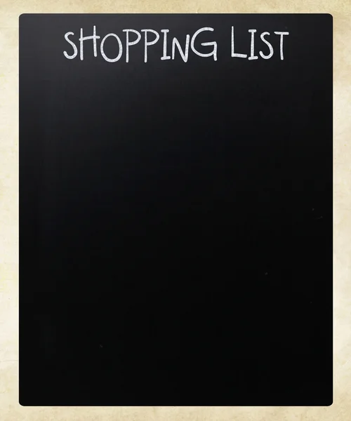 "Shopping list" handwritten with white chalk on a blackboard — Stock Photo, Image