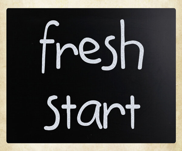 "fresh start" handwritten with white chalk on a blackboard