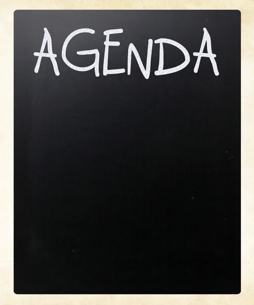 "AGENDA" handwritten with white chalk on a blackboard — Stock Photo, Image