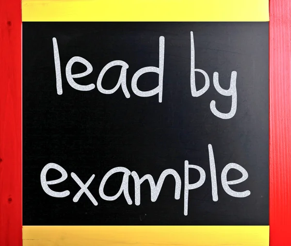 "Lead by example" handwritten with white chalk on a blackboard — Stok fotoğraf