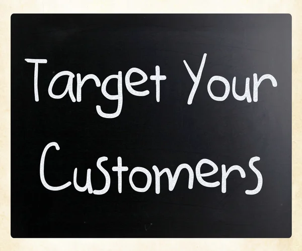 "Target your customers" handwritten with white chalk on a blackb — Stok fotoğraf