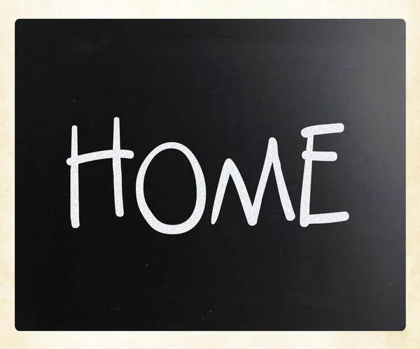 "Home "handwritten with white chalk on a blackboard — стоковое фото