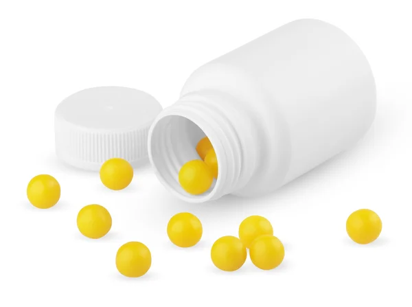 Open plastic bottle with yellow vitamins — Stock Photo, Image