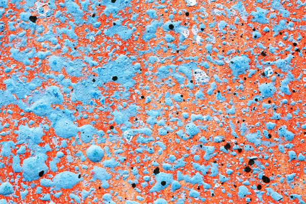 Blue paint splatter on red background — Stock Photo, Image