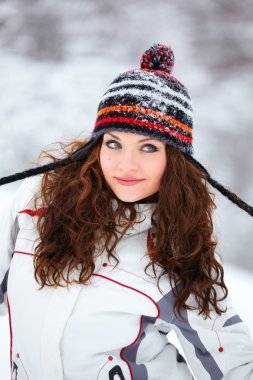 Young woman playing in the snow clipart