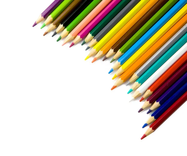 Lápices multicolores en una esquina sobre fondo blanco — Foto de Stock