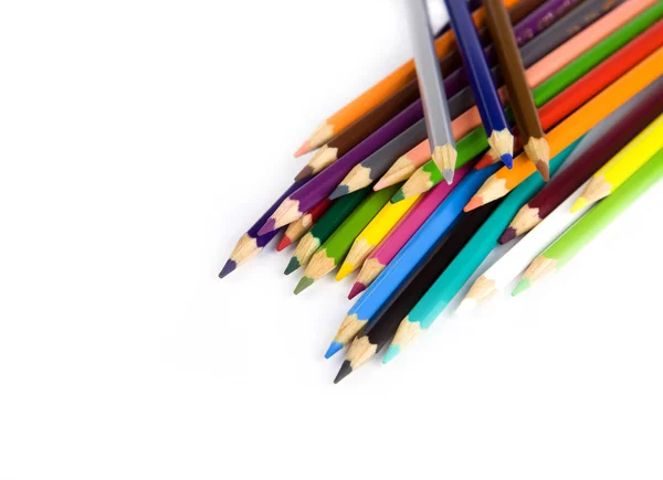 Multi gekleurde potloden in een hoek op witte achtergrond — Stockfoto