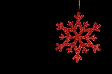 Red snow flake on a black background clipart