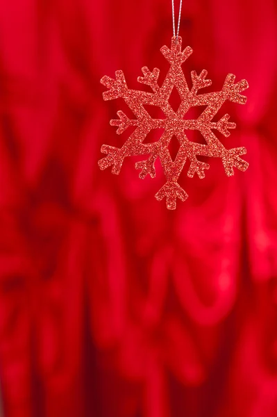 Red snow flake on a red background — Stock Photo, Image