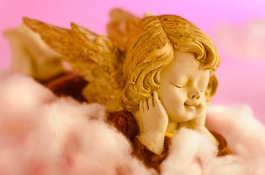 Angel resting on clouds and enjoying the sun clipart