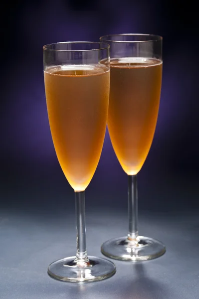 Champaign glass in front of blue purple background — Stock Photo, Image