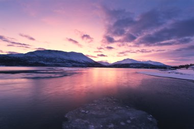 Twilight above a ford in Norway with beautifully colors clipart