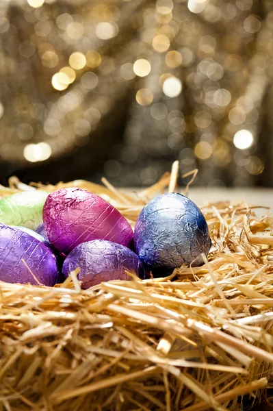 Chocolate Easter eggs in a natural straw nest — Stock Photo, Image