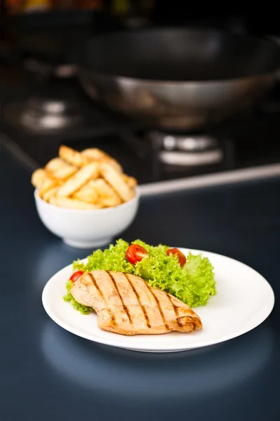Chicken, French fries and salad — Stock Photo, Image