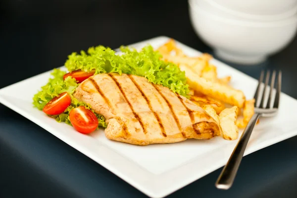 Chicken, French fries and salad — Stock Photo, Image