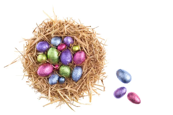 Straw nest with chocolate Easter eggs — Stock Photo, Image