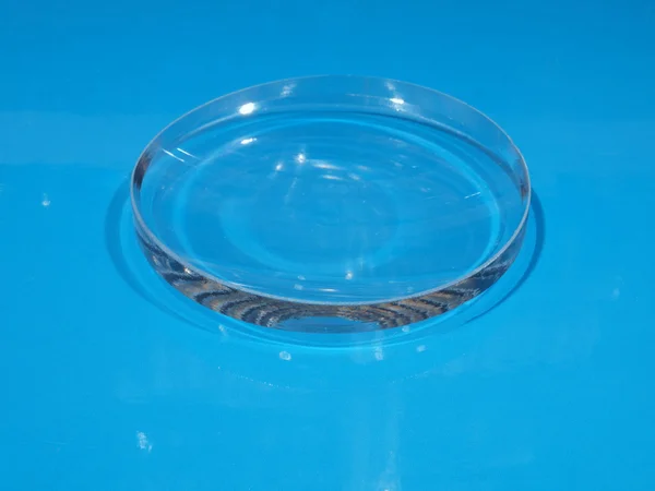 Glass lens on a blue background