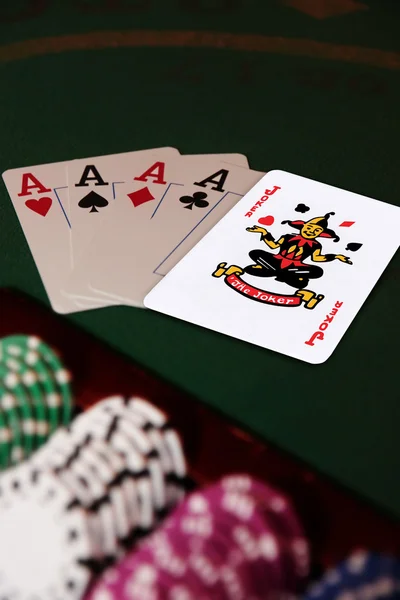 Four aces and joker in the pack — Stock Photo, Image