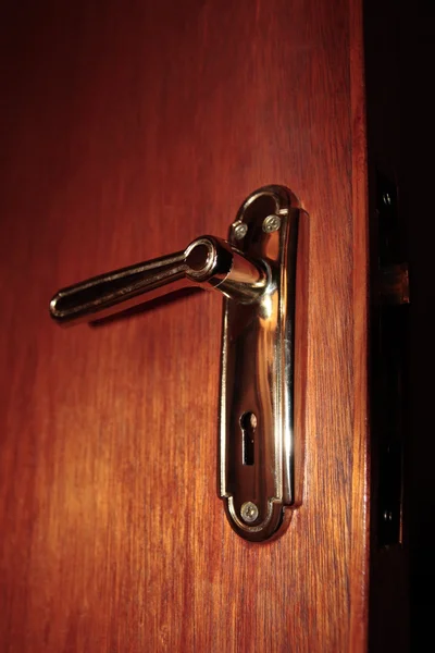 Brass door handle on wood — Stock Photo, Image