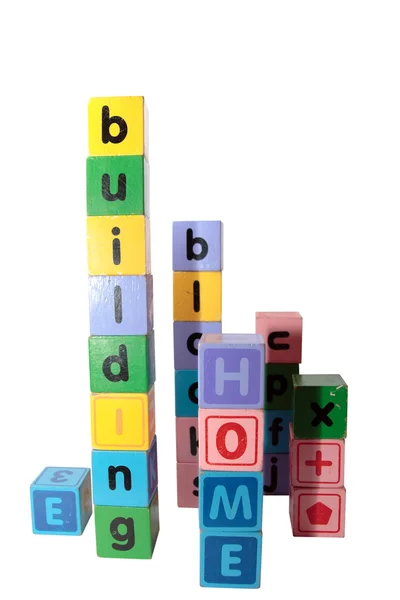 Hem byggstenar i bokstäver upprätt — Stockfoto