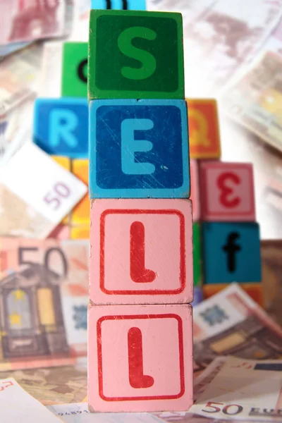 Sell in toy play block letters — Stock Photo, Image
