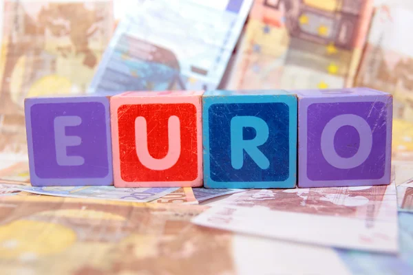 Euro in blocks on money — Stock Photo, Image