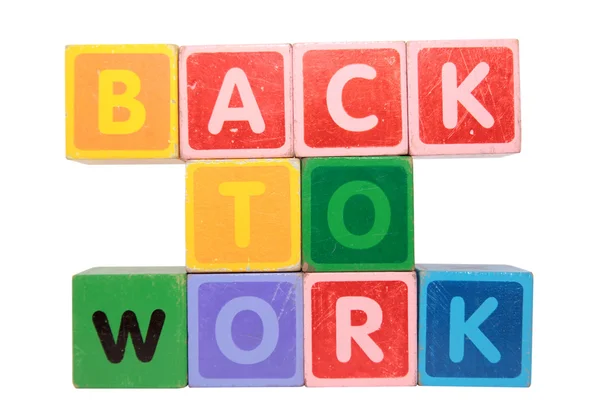 Voltar ao trabalho em letras de bloco de brinquedo — Fotografia de Stock