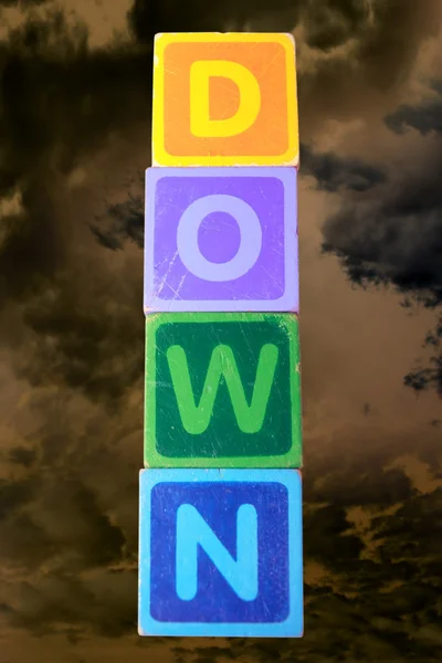 Down in toy play block letters with clipping path — Stock Photo, Image