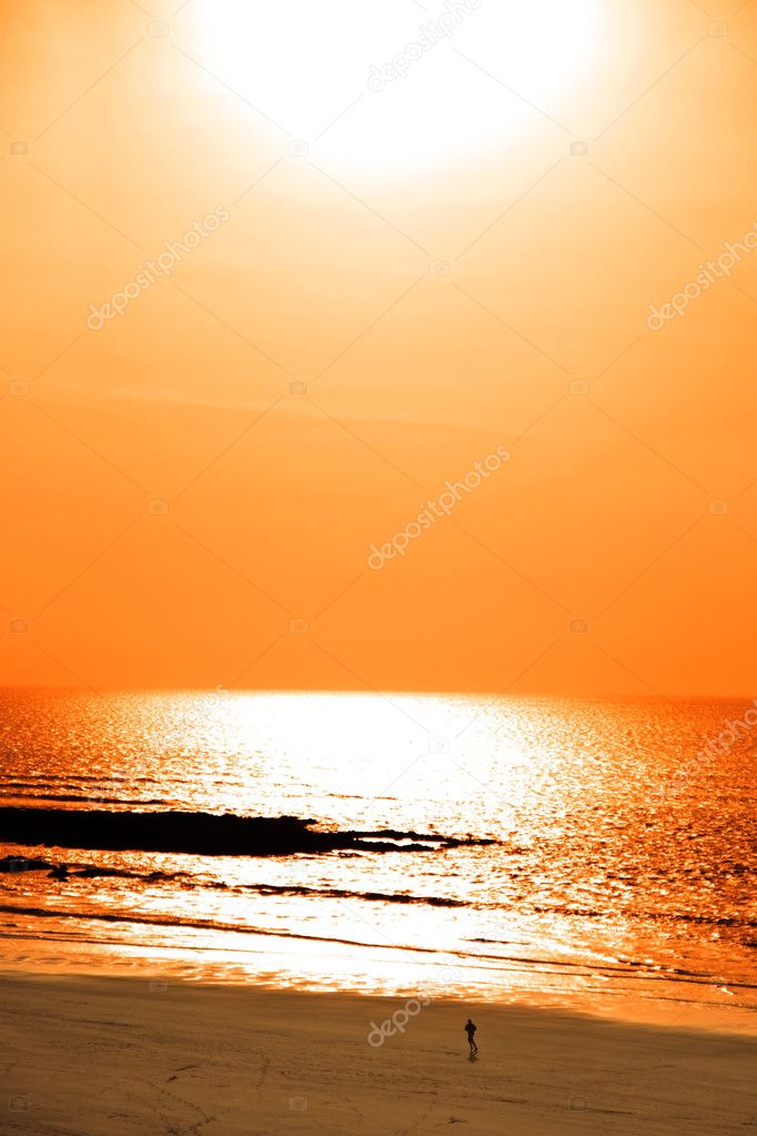 Running on sunshine reflected on a golden beach