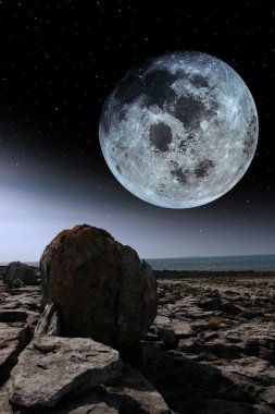 Full moon and boulders in rocky burren landscape clipart