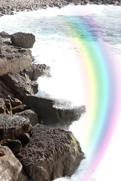 Ola estrellándose en acantilados de la costa con arco iris —  Fotos de Stock