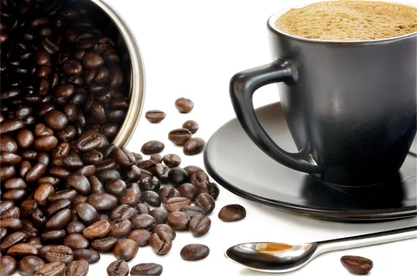 Coffee beans and black cup — Stock Photo, Image