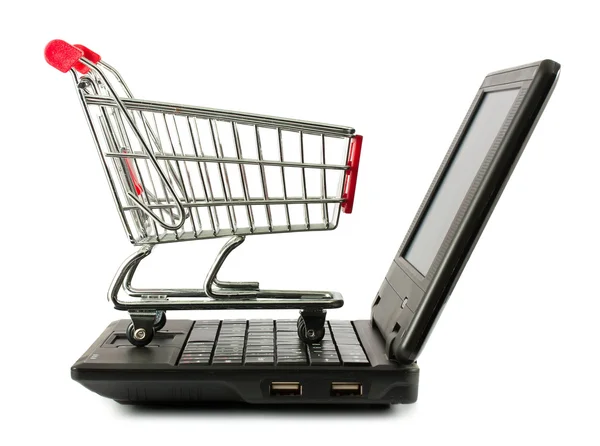 stock image Shopping cart over a laptop