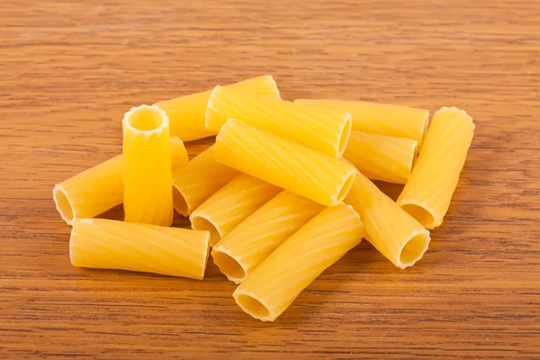 Macaroni on wooden background — Stock Photo, Image