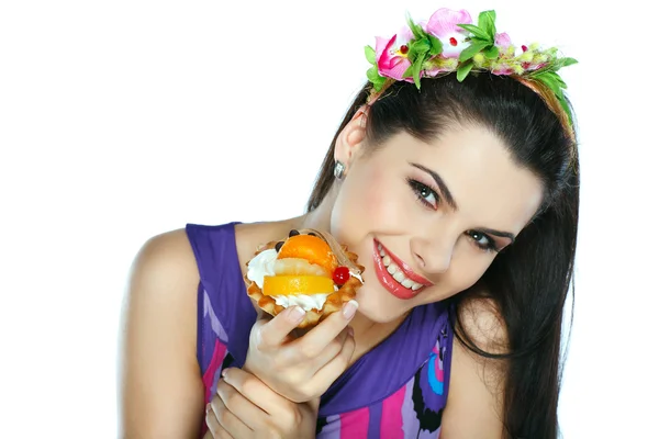 Young, beautiful brunette with fruit cake isolated on white — Stock Photo, Image