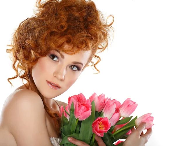 Beautiful redheaded girl with the bouquet of tulips isolated on a white background — Stock Photo, Image