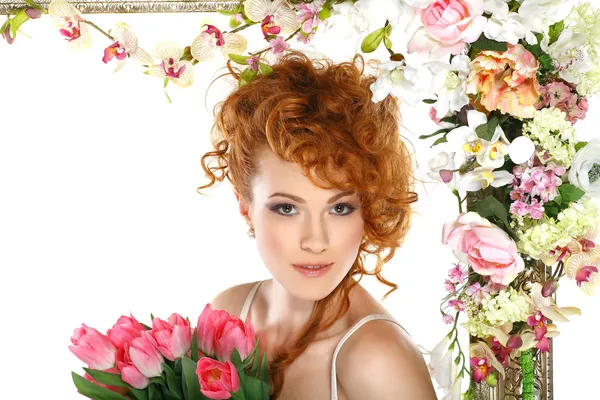 Beautiful redheaded girl with the bouquet of tulips, which stands in a gold frame, flowered, isolated on a white background — Stock Photo, Image